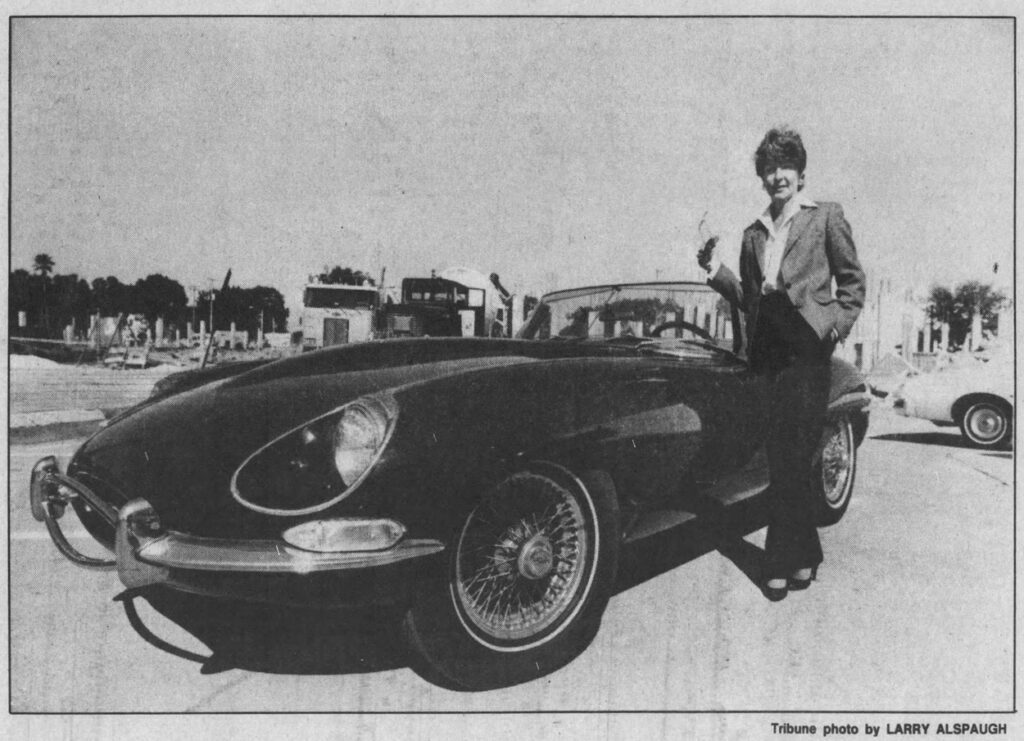 Brenda Taylor posing next to her 1968 Jaguar XKE sports car, Tampa Tribune photo by Larry Alspaugh